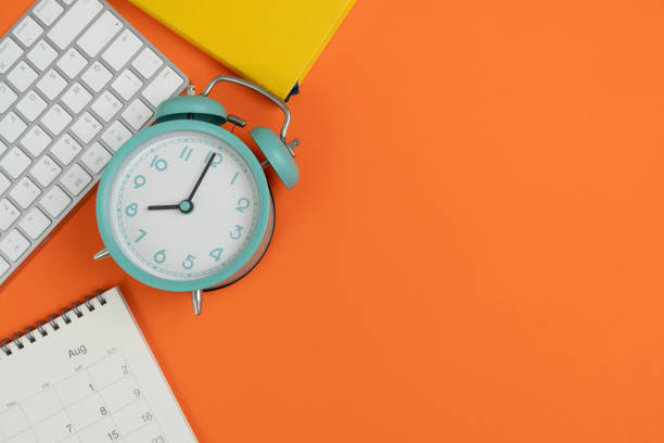 istock Engineer or architect desk with stationery, calendar, alarm clock on orange color table background in the office, project ideas concept 2169530593