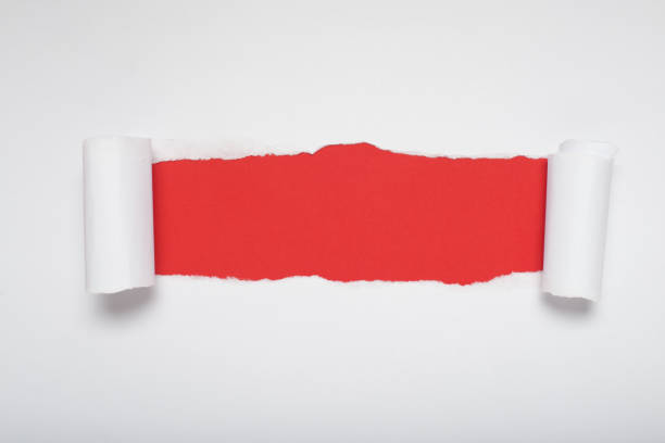 istock Torn white paper revealing a orange background. Space for text. 2169532059