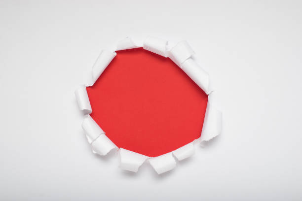 istock Torn white paper revealing a orange background. Space for text. 2169532060