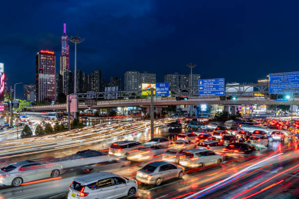 Busy traffic jam during rain and Landmark 81 of Dien Bien Phu St with numerous shop sign boards, crowded with people, motorbikes Ho Chi Minh city, Vietnam - 18 Jun 2024: Busy traffic jam during rain and Landmark 81 of Dien Bien Phu St with numerous shop sign boards, crowded with people, motorbikes vietnamese man taxi motorbike driver stock pictures, royalty-free photos & images