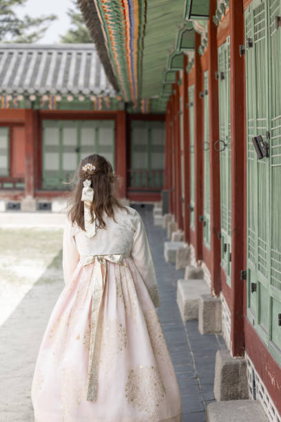 istock Woman in Traditional Hanbok Exploring Palace Grounds 2169541391