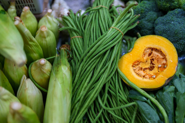 An array of multi-colored vegetables showcased on a farmer's market stall, showcasing fresh and vibrant produce.