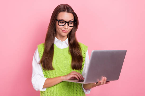 istock Photo of concentrated successful lady using modern device gadget preparing online lesson isolated on pink color background 2169543306