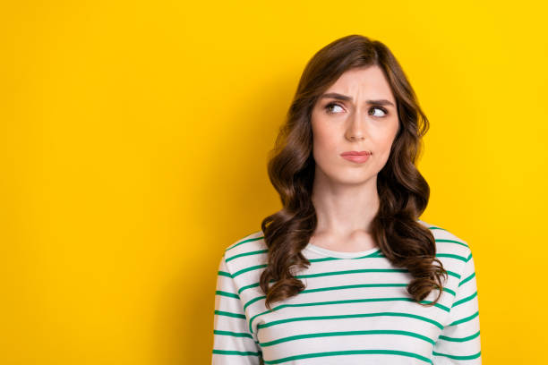 istock Photo of minded ponder thinking lady look empty space pouted lips distrust choosing product high price sceptical isolated on yellow color background 2169545965