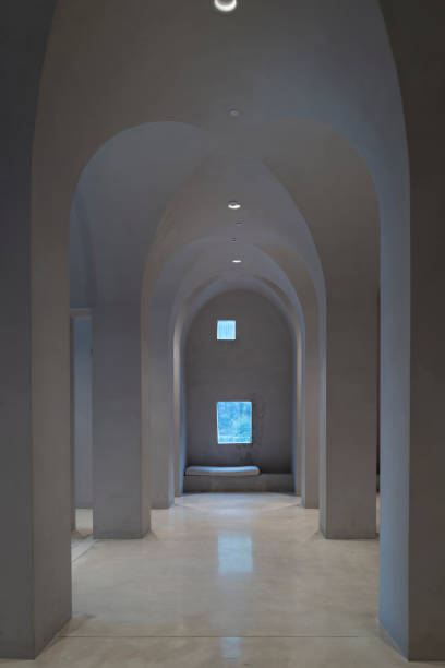 istock The lighting effect of an empty modern concrete curved corridor 2169546502