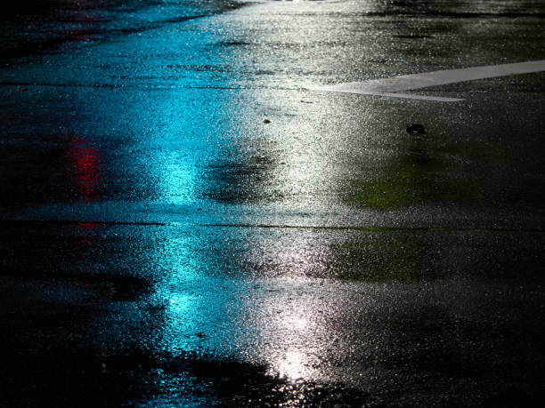 Reflection of Traffic light  on a wet road at night