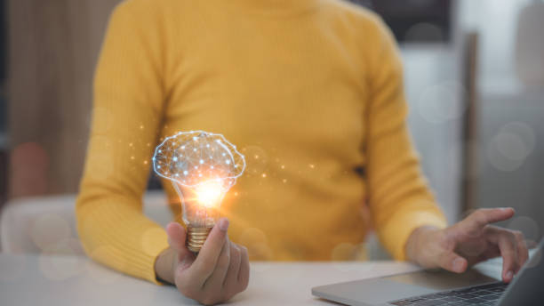 istock Women holding lightbulbs with virtual brains glowing, patent and creative idea innovation concept. 2169547508