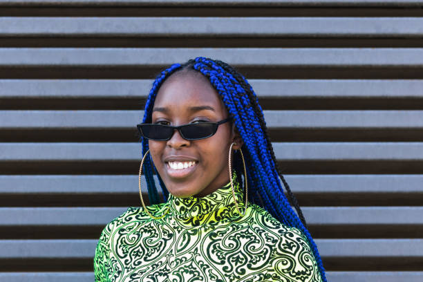 istock Smiling black woman in trendy clothes in city 2169548607