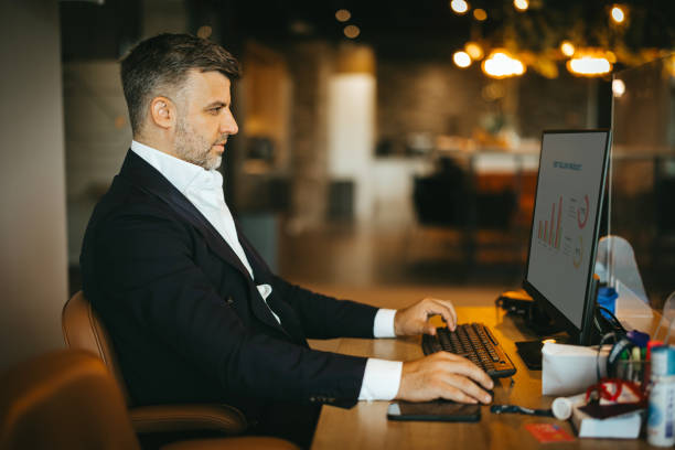 istock Side view of man typing on keyboard in office 2169550867