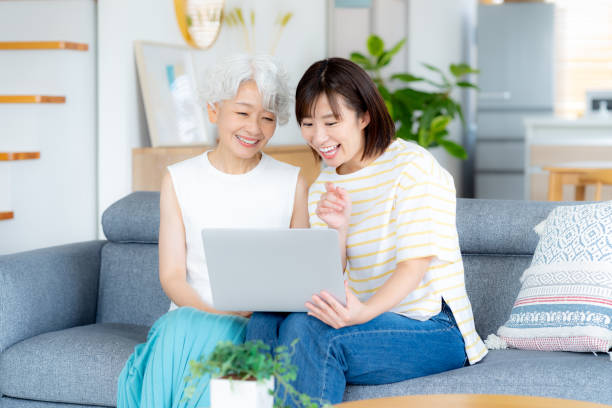 istock Senior woman learning how to use a computer in the living room 2169552018
