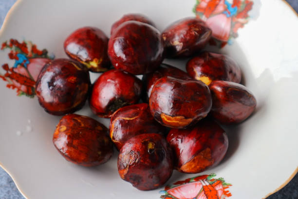 istock Raw jengkol on a white plate on a gray background 2169552022