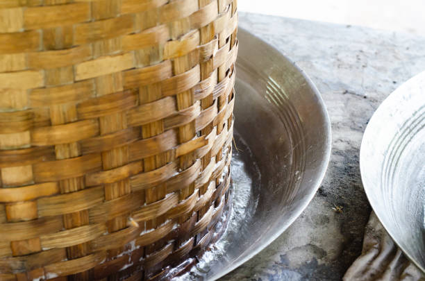 Asian man making boiled palm coconut sugar or cane production process  raw material  Amphawa  Thailand. Traditional culture lifestyle. Local sweet food.