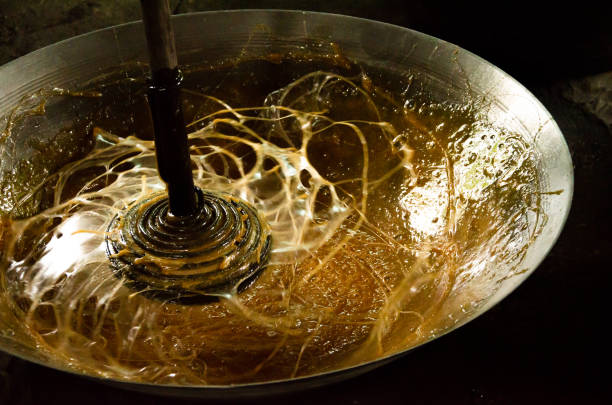 istock Asian man making boiled palm coconut sugar or cane production process  raw material  Amphawa  Thailand. Traditional culture lifestyle. Local sweet food. 2169553269