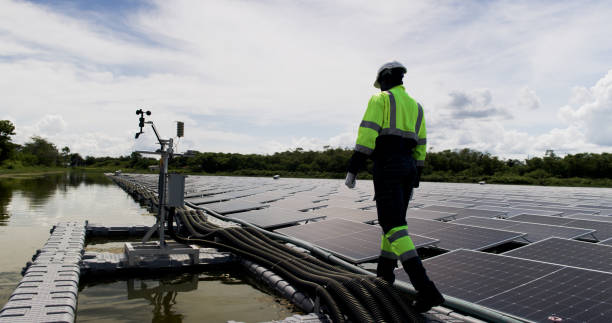 istock An African-American engineer carefully examines a cutting-edge floating solar panel system designed to harness renewable energy for an industrial complex. 2169554137
