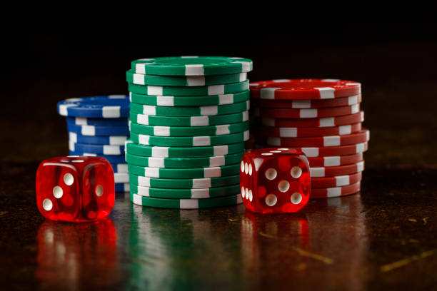 istock Stacks of of gambling chips and red dice 2169561295
