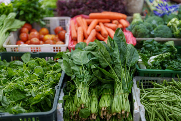 An array of multi-colored fruits and vegetables showcased on a farmer's market stall