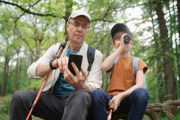 istock Little boy with his grandfather exploring nature in a forest 2169565174