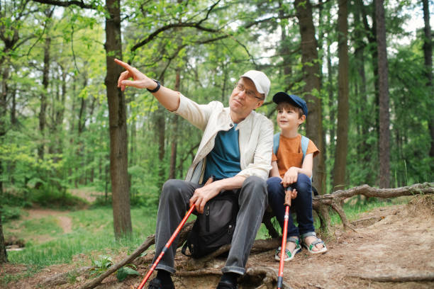 istock Little boy with his grandfather exploring nature in a forest 2169565208