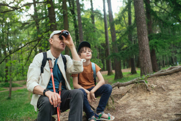 istock Little boy with his grandfather exploring nature in a forest 2169565362