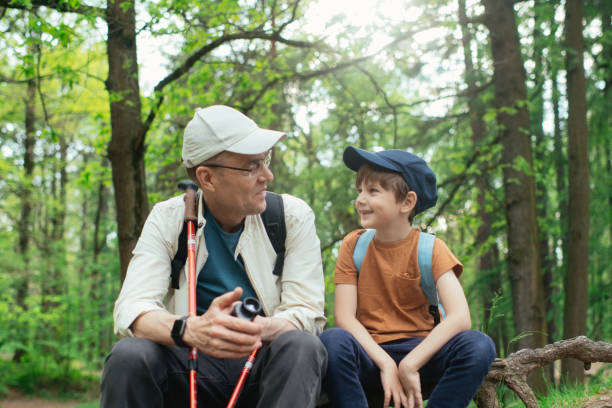 istock Little boy with his grandfather exploring nature in a forest 2169565391