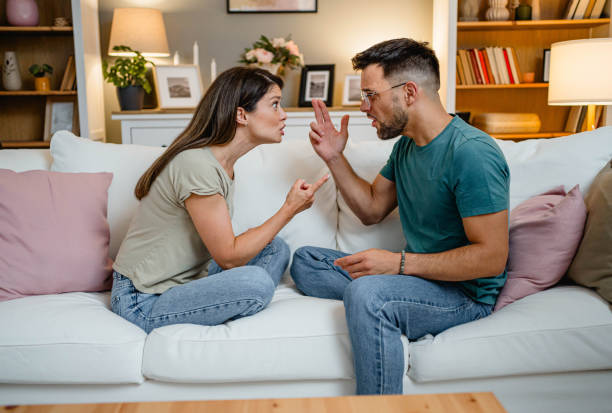 istock Husband and wife arguing on the couch 2169567031