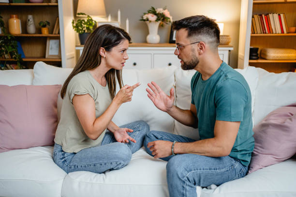 istock Husband and wife arguing on the couch 2169567064