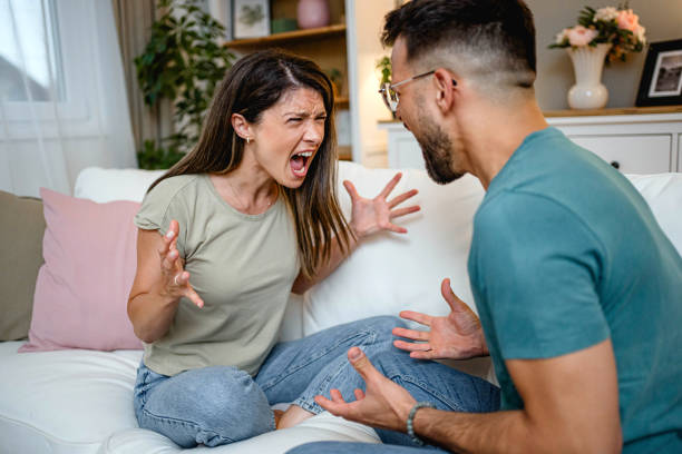 istock Husband and wife arguing on the couch 2169567091