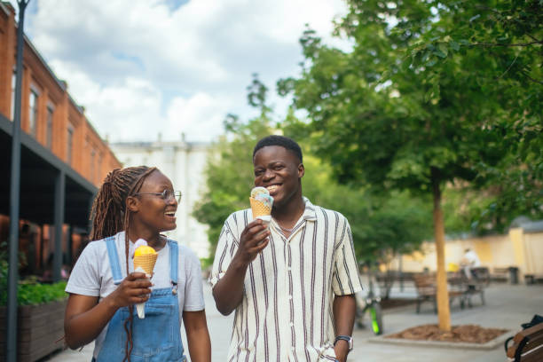 Young couple with ice-cream outdoors in summer