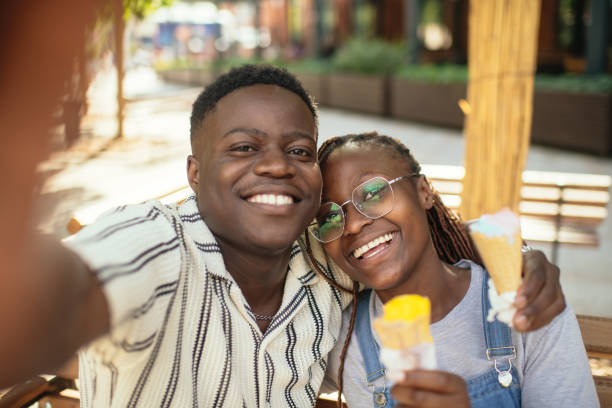 istock Young couple with ice-cream making selfie with smartphone outdoors in summer 2169576033
