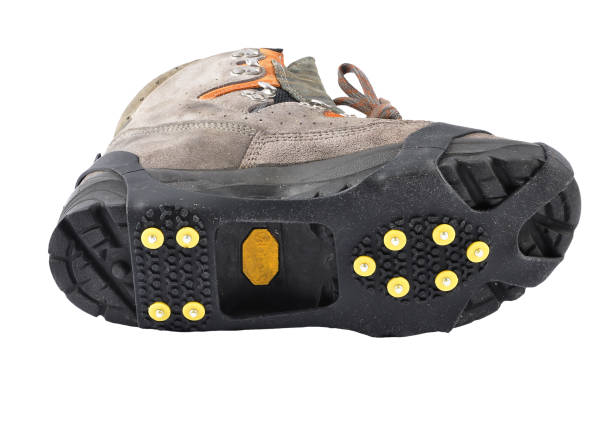Hiking shoes with spikes on a white background