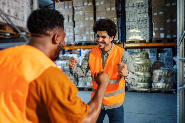 istock Excited cheerful multicultural storage workers celebrating winning at facility. 2169584957