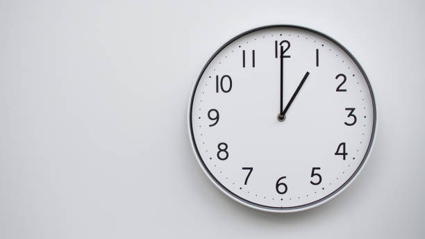 istock Minimalist Analog Wall Clock with White Face and Simple Black Hands Showing 01.00/13.00 - Ideal for Time Management and Modern Decor Concepts 2169588760