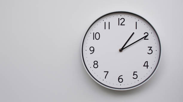 istock Minimalist Analog Wall Clock with White Face and Simple Black Hands Showing 01.10/13.10 - Ideal for Time Management and Modern Decor Concepts 2169588763