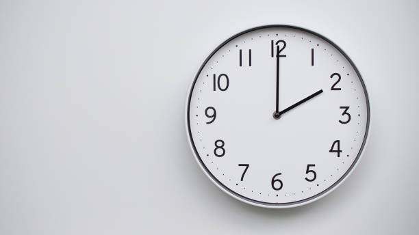 istock Minimalist Analog Wall Clock with White Face and Simple Black Hands Showing  - Ideal for Time Management and Modern Decor Concepts 2169588775