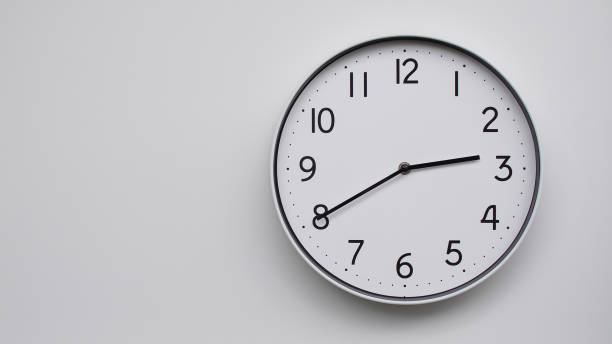 istock Minimalist Analog Wall Clock with White Face and Simple Black Hands Showing 14.40/02.40 - Ideal for Time Management and Modern Decor Concepts 2169588798