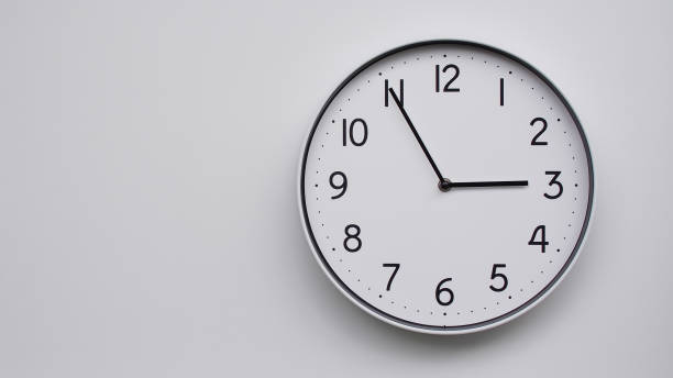 istock Minimalist Analog Wall Clock with White Face and Simple Black Hands Showing  - Ideal for Time Management and Modern Decor Concepts 2169588800