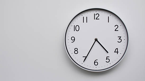 Minimalist Analog Wall Clock with White Face and Simple Black Hands Showing 16.35/04.35 - Ideal for Time Management and Modern Decor Concepts