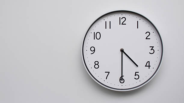 istock Minimalist Analog Wall Clock with White Face and Simple Black Hands Showing 16.30/04.30 - Ideal for Time Management and Modern Decor Concepts 2169589300