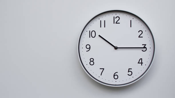 istock Minimalist Analog Wall Clock with White Face and Simple Black Hands Showing  10.15/22.15 - Ideal for Time Management and Modern Decor Concepts 2169590964