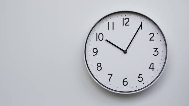 istock Minimalist Analog Wall Clock with White Face and Simple Black Hands Showing  22.05/10.05 - Ideal for Time Management and Modern Decor Concepts 2169590966