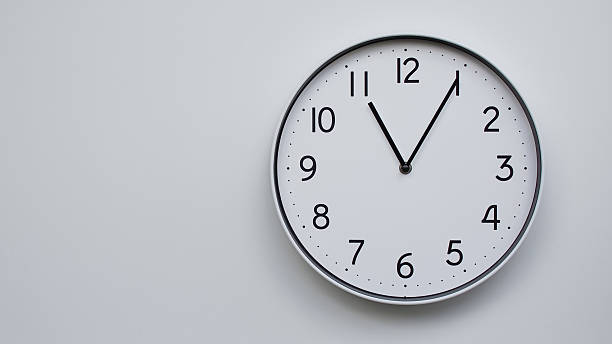 istock Minimalist Analog Wall Clock with White Face and Simple Black Hands Showing 11.05/23.05 - Ideal for Time Management and Modern Decor Concepts 2169590990