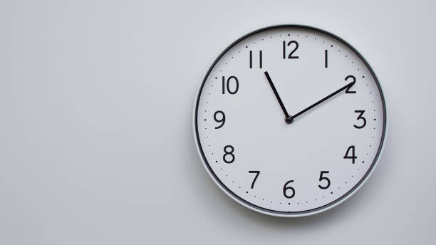 istock Minimalist Analog Wall Clock with White Face and Simple Black Hands Showing 11.10/23.10 - Ideal for Time Management and Modern Decor Concepts 2169590991
