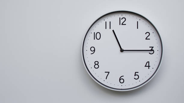 istock Minimalist Analog Wall Clock with White Face and Simple Black Hands Showing 11.15/23.15 - Ideal for Time Management and Modern Decor Concepts 2169591004