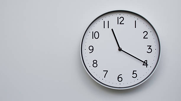 istock Minimalist Analog Wall Clock with White Face and Simple Black Hands Showing 11.20/23.20 - Ideal for Time Management and Modern Decor Concepts 2169591005