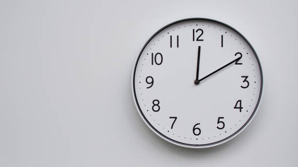 istock Minimalist Analog Wall Clock with White Face and Simple Black Hands Showing 12.10/00.10 - Ideal for Time Management and Modern Decor Concepts 2169591029