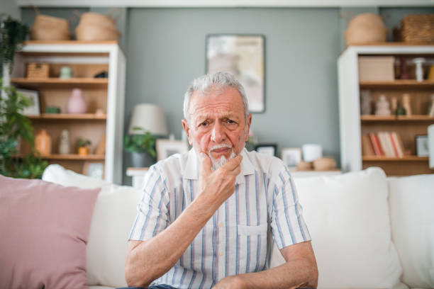 istock A man has a severe toothache while sitting in the living room 2169601067