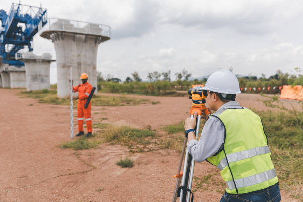 istock Surveyor engineer worker making measuring with theodolite tool equipment at construction site. Surveyors or explorer view construction sites or check security 2169603690