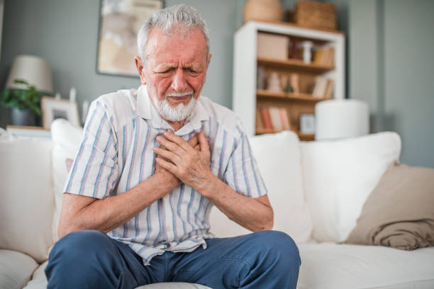 istock Mature man suffering from chest pain while sitting on sofa at home 2169603885