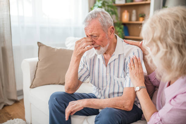 istock Senior lady comforting her husband with headache 2169604071