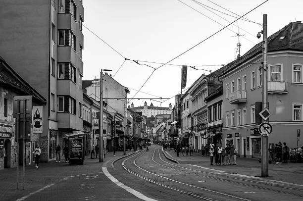 a street in the historic center of Bratislava with tram tracks running through it